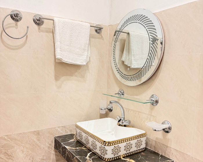 A Hotel Room With A Cozy Bed, A Functional Desk, A Comfortable Chair, A Bright Lamp, And A Stylish Mirror at The Decent Luxury Guest House - 4